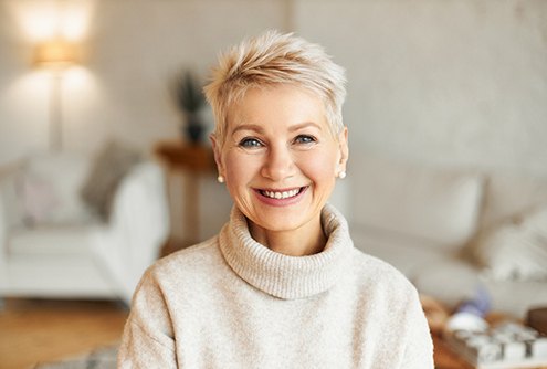 Smiling senior woman happy she got dental bridge