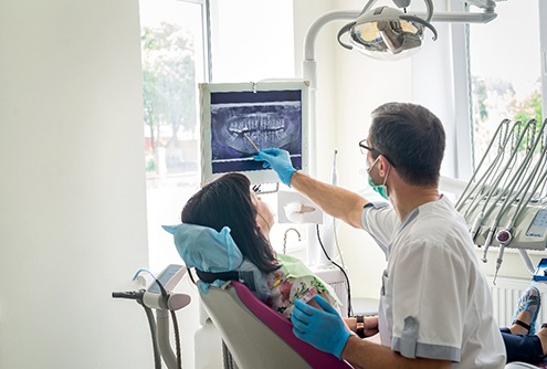 Dentist showing a patient a dental x-ray