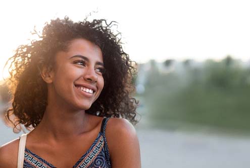 young woman smiling after getting dental crown in McMinnville