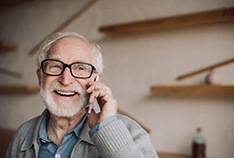 A senior man talking into his cell phone