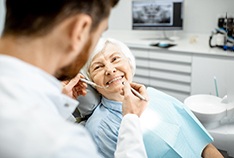 An elderly woman receiving a dental checkup