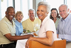 An elderly woman socializing with other seniors