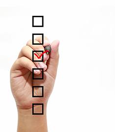hand using marker to update checklist 