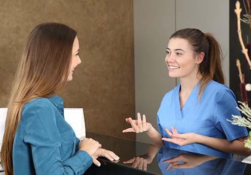 Dentist and patient discussing the cost of dental emergencies in McMinnville 