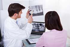 McMinnville emergency dentist and patient looking at X-rays
