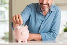 Smiling man saving up for the cost of a dental emergency in McMinnville 