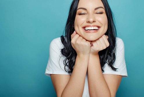 Woman smiles after wearing Invisalign in McMinnville