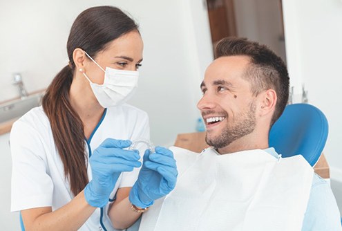 Dentist and patient discuss the cost of Invisalign in McMinnville 