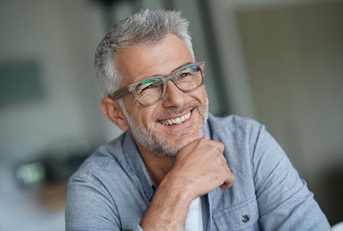 older man with glasses smiling 