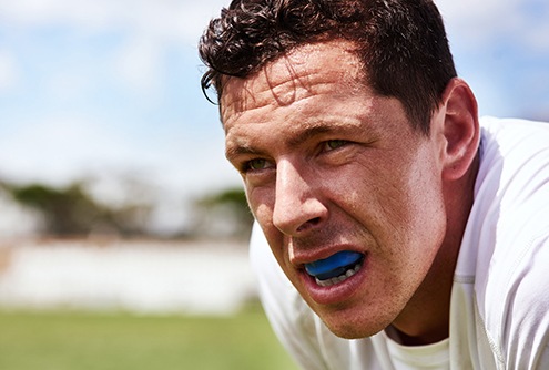 a man on a field wearing a mouthguard