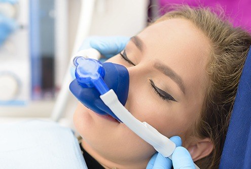 Woman with nitrous oxide nose mask