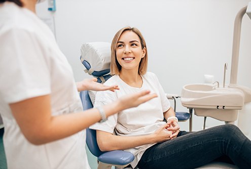 Patient smiling while talking to cosmetic dentist in McMinnville