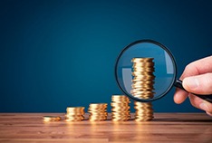 Stacks of coins measured with magnifying glass