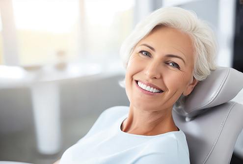 Woman smiling while sitting in treatment chair