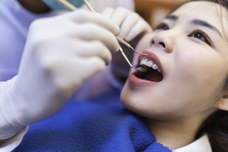 a young woman having her teeth checked