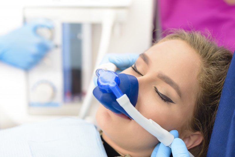 a young woman receiving nitrous oxide sedation while at the dentist’s office