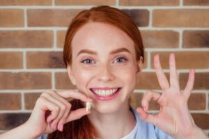 Woman smiling after a tooth extraction