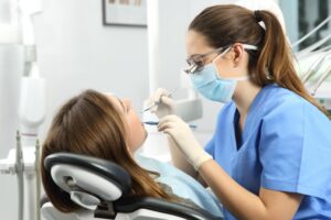 Dentist cleaning patient's teeth.